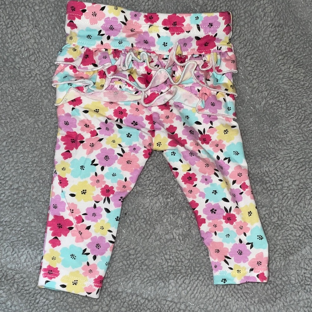 flower pants are 0-3m and the light green ones are 6-9M